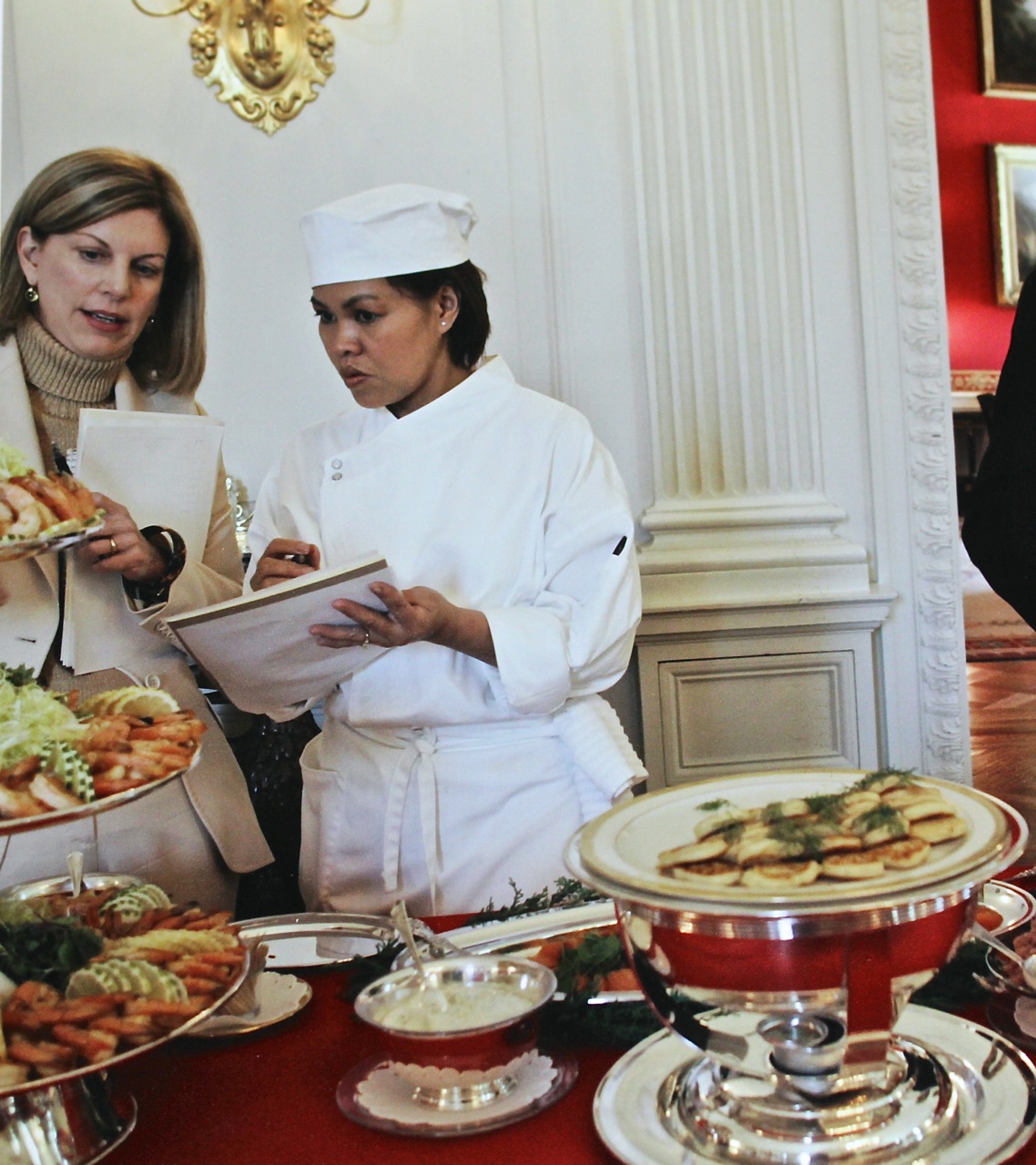 Caption: Cris and Lea Berman reviewing notes at a tasting for a White House Christmas buffet in 2005