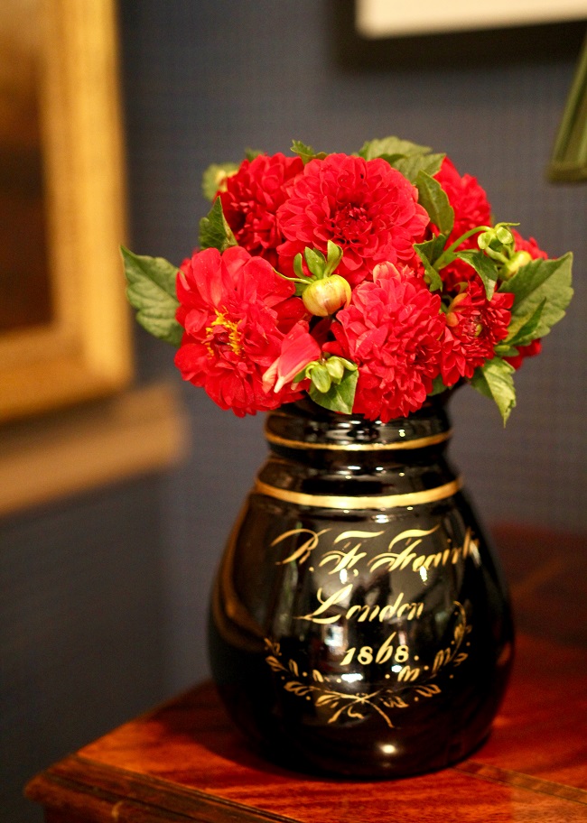 Red Dahlias in black London vase